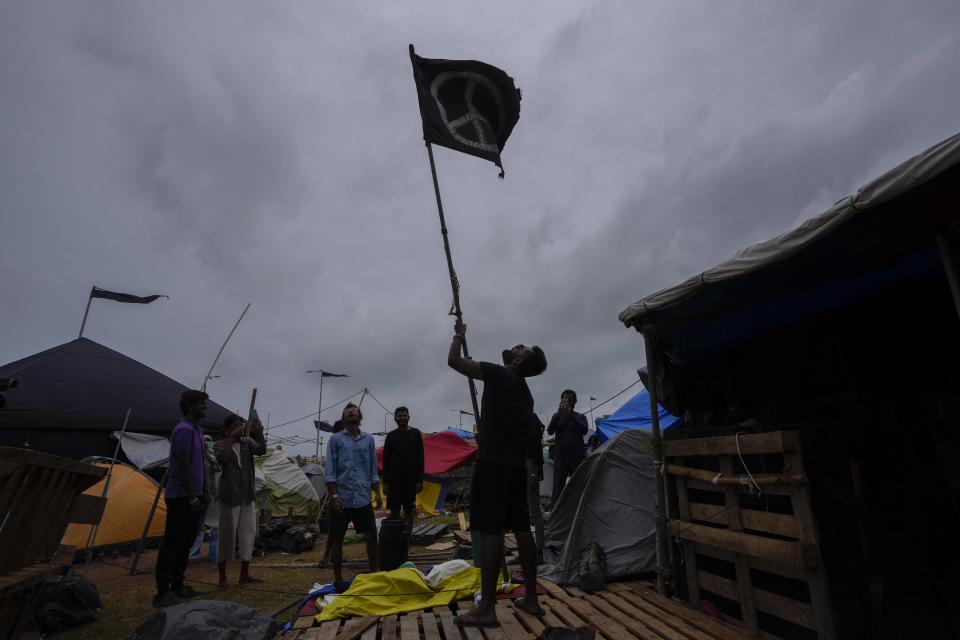 A group of protesters dismantle their tents as they prepare to vacate the site of months long anti government protest site outside the president's office in Colombo, Sri Lanka, Thursday, Aug. 4, 2022. (AP Photo/Eranga Jayawardena)