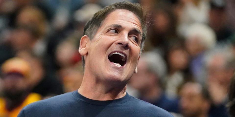 Mark Cuban smiles during an NBA game.