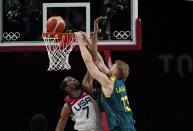 Australia's Jock Landale (13) goes to the basket over United States's Kevin Durant (7) during men's basketball semifinal game at the 2020 Summer Olympics, Thursday, Aug. 5, 2021, in Saitama, Japan. (AP Photo/Eric Gay)