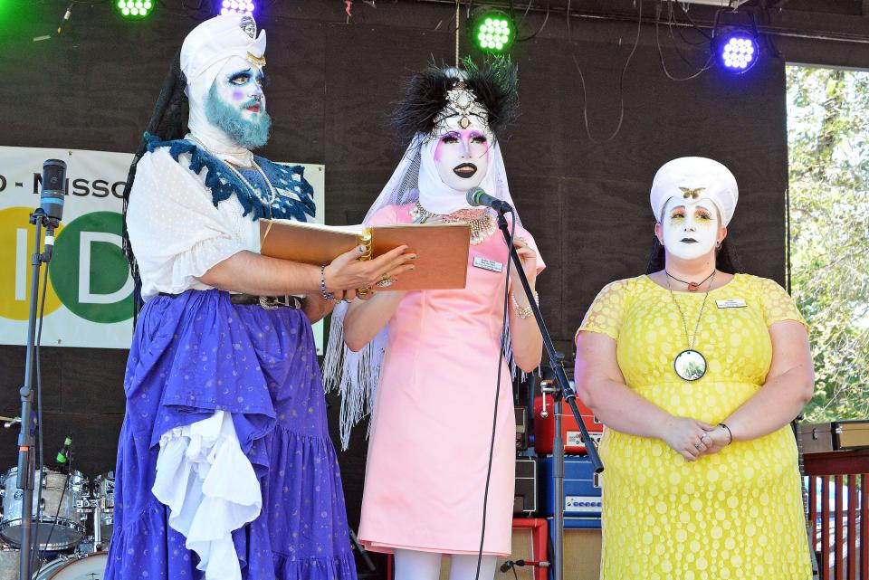 Novice Molly Alice Minx, center, with the City of Fountains Sisters of Perpetual Indulgence, reads a blessing Saturday for the Mid-MO PridFest during opening ceremonies at Rose Music Hall.
