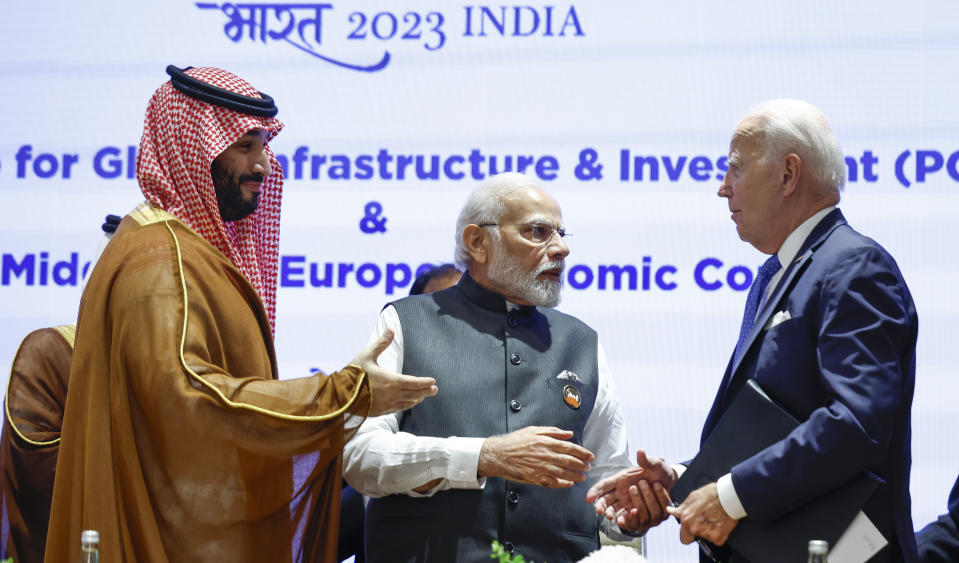 Saudi Arabian Crown Prince Mohammed bin Salman Al Saud, left, U.S. President Joe Biden, right, and Indian Prime Minister Narendra Modi talk on the day of the G20 summit in New Delhi, India, Sept. 9, 2023. (AP Photo/Evelyn Hockstein, Pool)