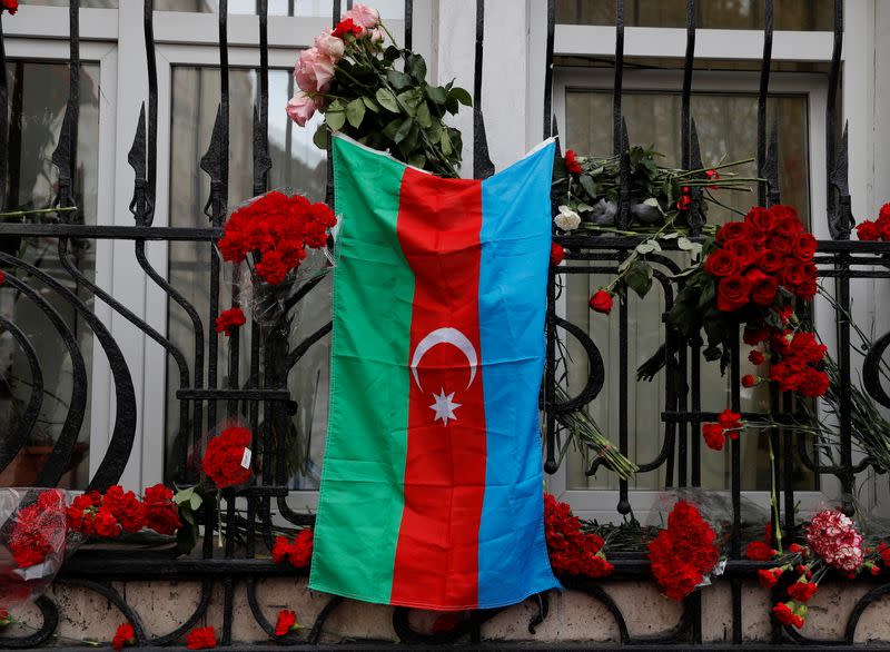 The national flag of Azerbaijan hangs at a makeshift memorial for people killed in the country during the military conflict over the breakaway region of Nagorno-Karabakh, in Moscow