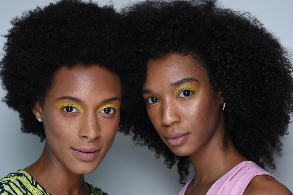 <p>Curly-haired models turn heads with bright yellow eyeshadow. (Photo: NARS) </p>