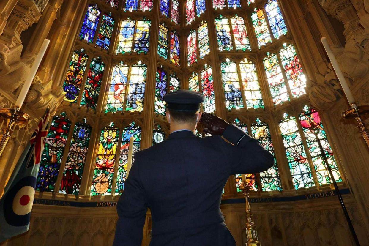 A member of the armed forces salutes at a service marking the 80th anniversary of the Battle of Britain: POOL/AFP via Getty Images