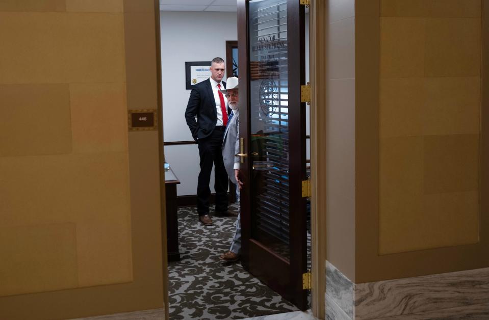 Sen. Tom Woods visits monday with Sen. Blake Stephens in Stephens' office.