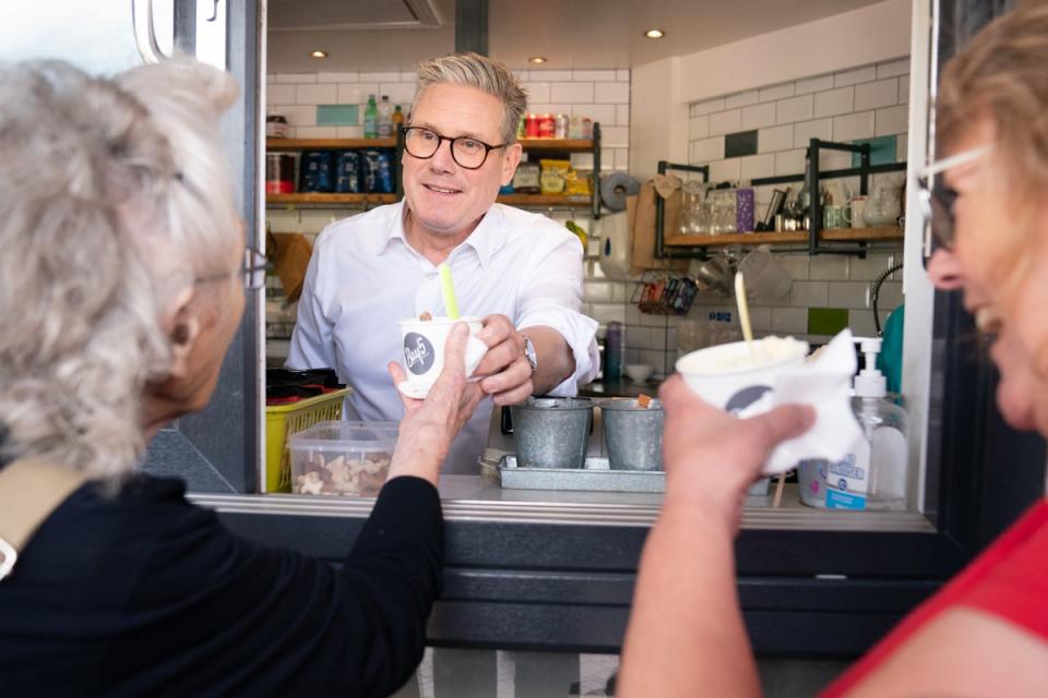 Sir Keir Starmer serves ice-cream on a visit to Barry in south Wales (Stefan Rousseau/PA Wire)