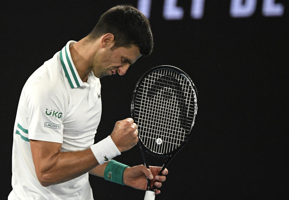 Serbia's Novak Djokovic reacts after winning a point against Russia's Daniil Medvedev during the men's singles final at the Australian Open tennis championship in Melbourne, Australia, Sunday, Feb. 21, 2021.(AP Photo/Andy Brownbill)