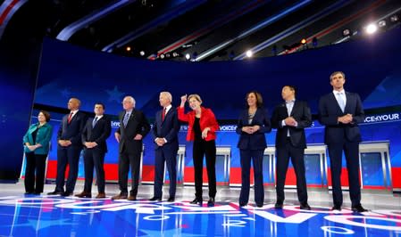 Democratic presidential candidates Klobuchar, Booker, Buttigieg, Sanders, Biden, Warren, Harris, Yang, O'Rourke and Castro pose before the start of the debate in Houston