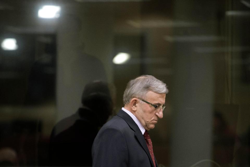 Vladimir Lazarevic enters the Yugoslav war crimes tribunal courtroom in The Hague Thursday, Jan. 23, 2014. Nikola Sainovic, Nebojsa Pavkovic, Sreten Lukic, and Vladimir Lazarevic, four former high-ranking Yugoslav and Serbian political, military and police officials who were convicted in 2009 for crimes committed against Kosovo Albanians in 1999 during Serbia’s deadly crackdown on ethnic Albanians appeared in court at the Yugoslav war crimes tribunal ahead of a decision in their appeal. (AP Photo/Peter Dejong, Pool)