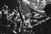 FILE - Los Angeles Lakers' Magic Johnson raises his hands as he acknowledges the crowd, June 8, 1982, in Los Angeles after the Lakers defeated the Philadelphia 76ers, to take the NBA Playoff Series four games to two. (AP Photo/Lennox McLendon, File)