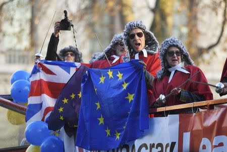 Protesters wearing judges' wigs and robes ride an open top bus past the Supreme Court ahead of the challenge against a court ruling that Theresa May's government requires parliamentary approval to start the process of leaving the European Union, in Parliament Square, central London, Britain December 5, 2016. REUTERS/Toby Melville