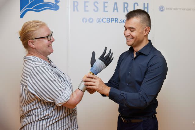 <p>SWNS</p> Karin (left) and Prof. Max Ortiz Catalan photographed fitting Karin's bionic arm