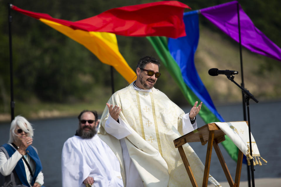 Rev. Dr. Jared Cramer of St. John's Episcopal Church and clergy members are seen during a pride worship service at the Lynne Sherwood Waterfront Stadium in Grand Haven, Mich., on Saturday, June 10, 2023. The festival — which organizers had hoped would attract at least 500 attendees — drew thousands of people from all over who came to experience the first-time event's drag show, dance party and vendor-filled streets. (AP Photo/Kristen Norman)