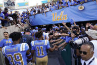FILE - UCLA football players greet fans as they leave the field after a 42-32 win over Utah in an NCAA college football game in Pasadena, Calif., Saturday, Oct. 8, 2022. Colorado becomes the third school to leave the Pac-12 in the last year, joining UCLA and Southern California, which are joining the Big Ten next year. (AP Photo/Ashley Landis, File)
