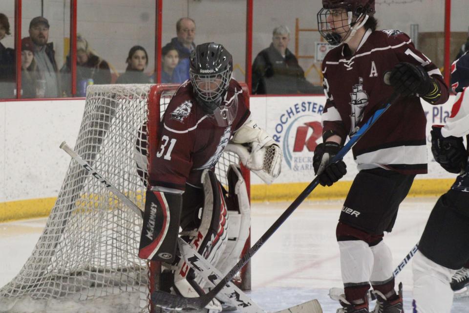 Portsmouth High School goalie Nico Mugica looks for the puck during Wednesday's game against Somersworth/Coe-Brown at Rochester Ice Arena.