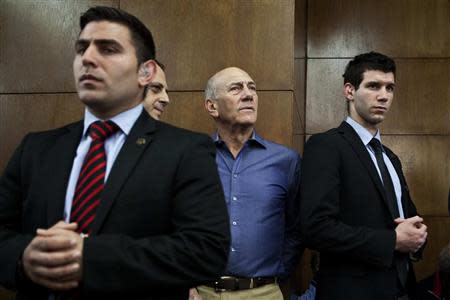 Former Israeli Prime Minister Ehud Olmert (2nd R) waits to hear his verdict at the Tel Aviv District Court March 31, 2014. REUTERS/Dan Balilty/Pool