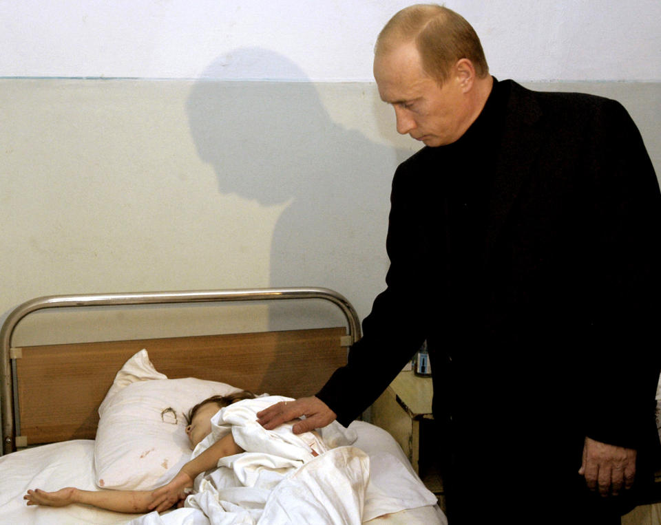 FILE - Russian President Vladimir Putin visits a hospital in Beslan, to meet victims of the hostage crisis in Beslan, Russia, on Sept. 4, 2004. Islamic militants seize a school in the southern city of Beslan, and more than 300 people die in the chaotic explosions and shootout that end the siege two days later. (Sputnik, Kremlin Pool Photo via AP, File)