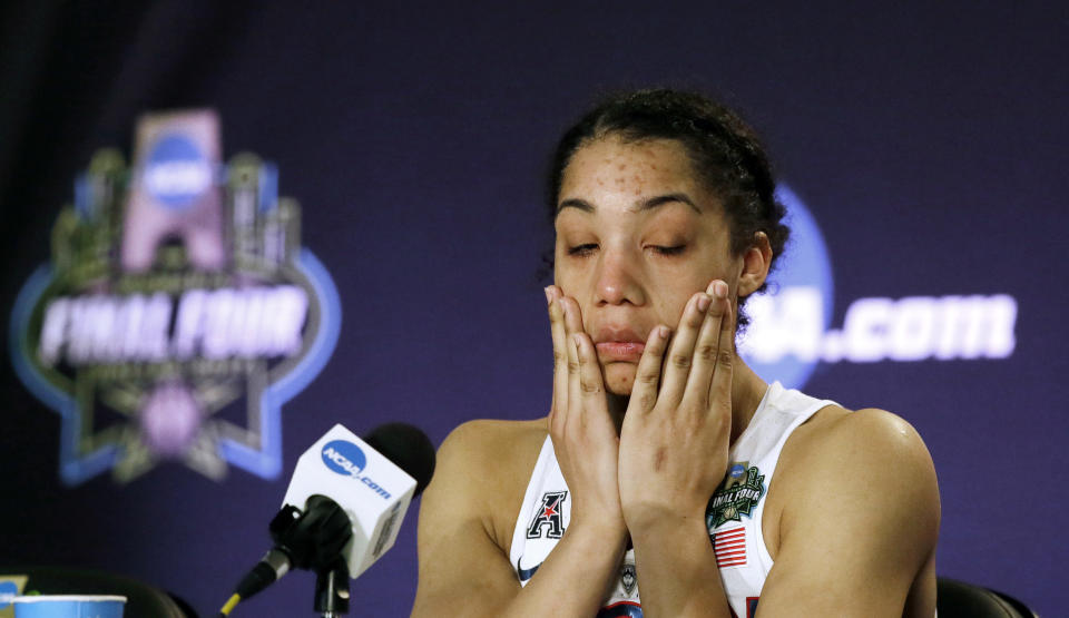 FILE - Connecticut guard Gabby Williams wipes away tears as she talks with the media following the team's 66-64 loss to Mississippi State in an NCAA college basketball game in the semifinals of the women's Final Four in Dallas, March 31, 2017. (AP Photo/LM Otero, File)