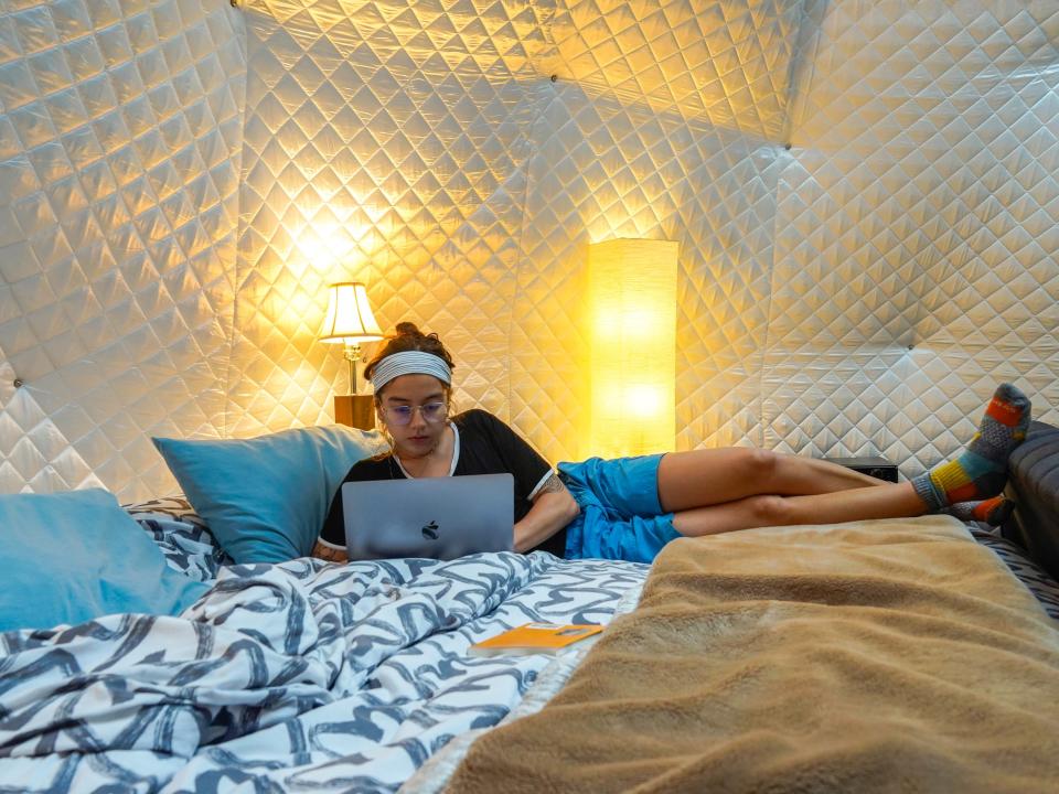 The author works on her laptop in bed in the dome