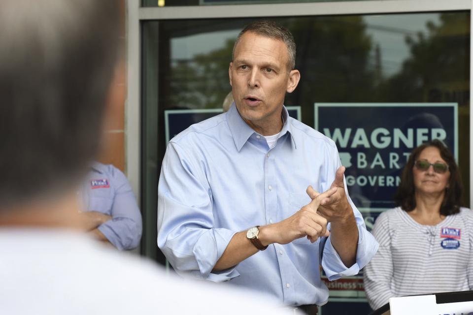 In this Oct. 6, 2018 photo, Republican U.S. Rep. Scott Perry of Pennsylvania listens to speakers at a party rally with volunteer canvassers, in Harrisburg, Pa. A court-ordered redrawing of Pennsylvania's House districts has forced several Republican congressmen, including Perry, into more competitive seats and helped establish Pennsylvania as a key state for Democrats aiming to recapture the House majority. (AP Photo/Marc Levy)