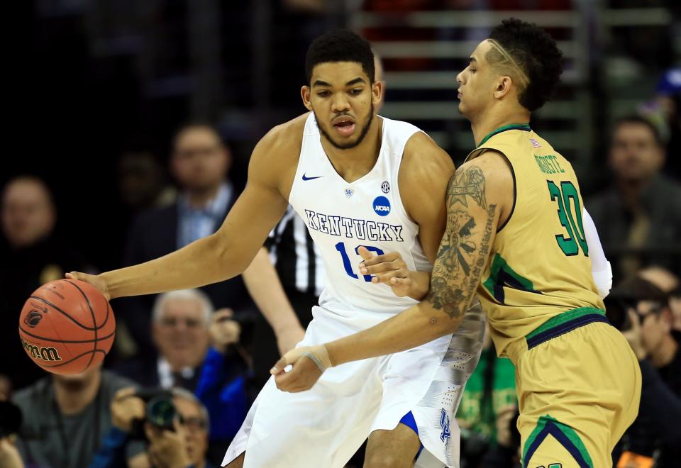 Kentucky forward Karl-Anthony Towns is guarded by Notre Dame forward Zach Auguste during an NCAA Tournament game on March 28, 2015.