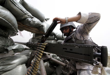 A Saudi soldier loads ammunition at their position at Saudi Arabia's border with Yemen, April 6, 2015. Concerns about the border with Yemen have been central to Saudi Arabia's campaign to stop the Houthis controlling its southern neighbor, something Riyadh fears would strengthen its main foe, Iran, and heighten security risks. REUTERS/Faisal Al Nasser