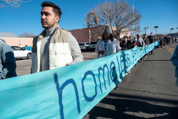 PHOTO: People carry a banner during a silent march to Wells Park to honor the memories of Homeless who died in 2022, in Albuquerque, on Dec. 21, 2022. (Adolphe Pierre-Louis/Albuquerque Journal via ZUMA Press)