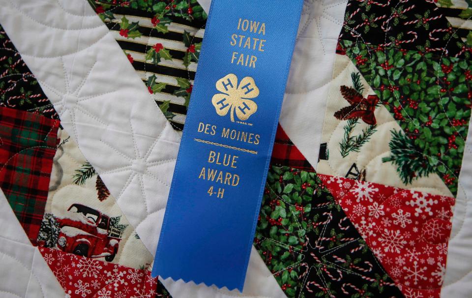 A blue ribbon awarded quilts fabricated by a 4-H student on display at the Jacobson Exhibition Center at the Iowa State Fair in 2021.