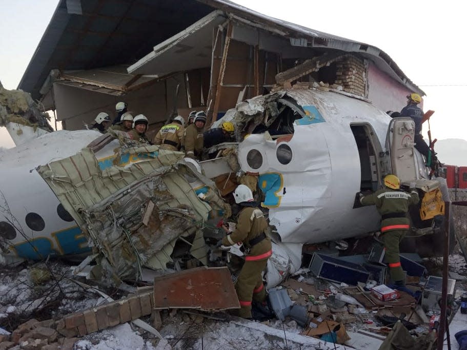 Emergency and security personnel are seen at the site of a plane crash near Almaty, Kazakhstan, December 27, 2019.