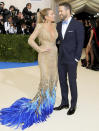 <p>In 2017, <a href="https://people.com/style/met-gala-best-dressed-editors-picks/" rel="nofollow noopener" target="_blank" data-ylk="slk:Lively and Reynolds returned to the Met Gala;elm:context_link;itc:0;sec:content-canvas" class="link ">Lively and Reynolds returned to the Met Gala</a> in <a href="https://people.com/style/blake-lively-ryan-reynolds-met-gala/" rel="nofollow noopener" target="_blank" data-ylk="slk:coordinating looks;elm:context_link;itc:0;sec:content-canvas" class="link ">coordinating looks</a>. Lively donned a gold Atelier Versace dress with blue feather detail, while Reynolds matched his tie to her outfit. </p>