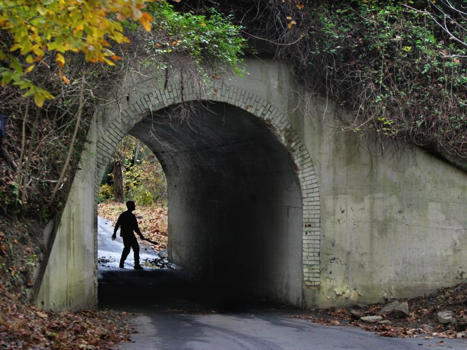 A man walks beneath bunnyman bridge