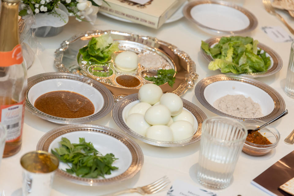 Symbolic food being placed in special Seder plates for the Passover feast. 