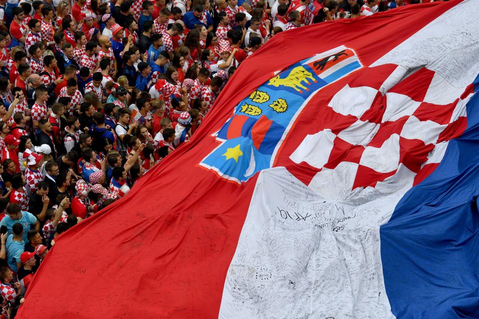 <p>Croatian supporters hold a huge Croatian flag in downtown Zagreb on July 15, 2018, as they gather to watch the Russia 2018 World Cup final football match between France and Croatia, the first final World Cup match ever in the history of Croatia. (Getty Images) </p>