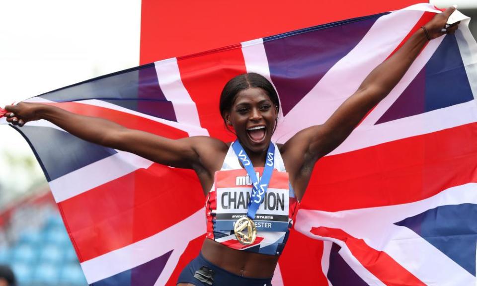Daryll Neita poses with her gold medal and holds the union flag after wining the women’s 200m.
