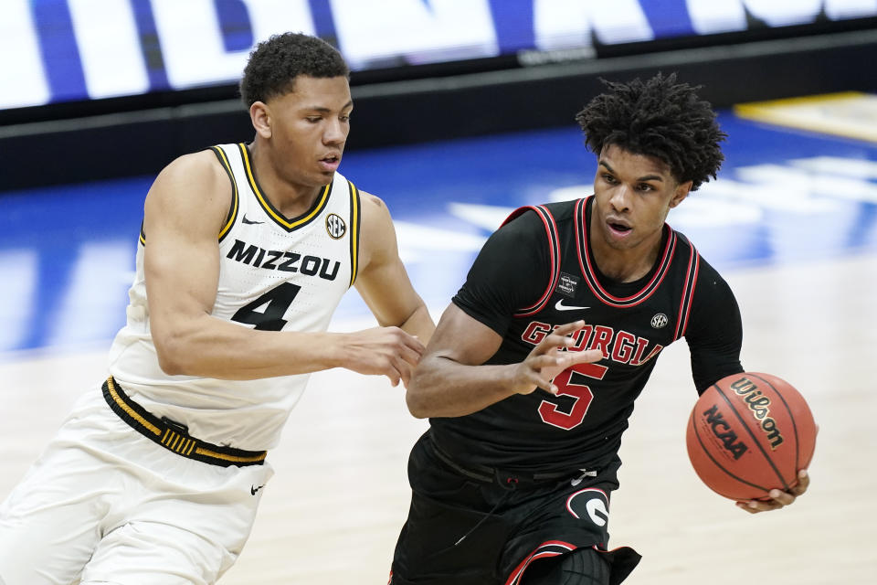 Missouri's Javon Pickett (4) defends against Georgia's Justin Kier (5) in the first half of an NCAA college basketball game in the Southeastern Conference Tournament Thursday, March 11, 2021, in Nashville, Tenn. (AP Photo/Mark Humphrey)