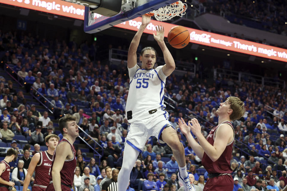 Kentucky's Lance Ware (55) dunks between Bellarmine's Peter Suder (5), Bash Wieland and Curt Hopf, right, during the first half of an NCAA college basketball game in Lexington, Ky., Tuesday, Nov. 29, 2022. (AP Photo/James Crisp)