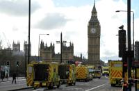 Members of the emergency services work to help vicitms on Westminster Bridge, alongside the Houses of Parliament in central London on March 22, 2017