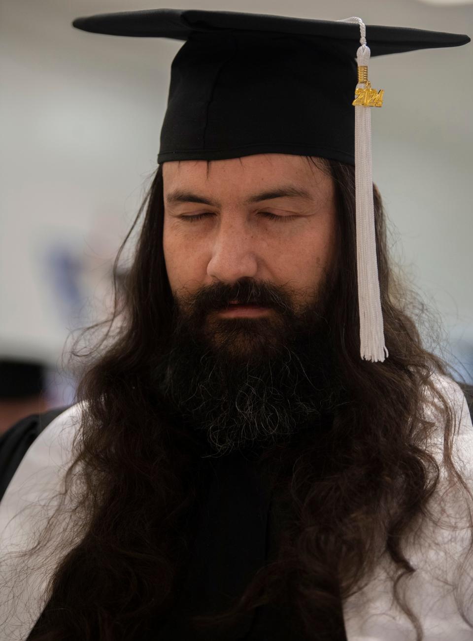 Allen Ellenburg closes his eyes in prayer during a graduation ceremony from an addiction program at Trousdale Turner Correctional Center in Trousdale County, Tenn., Friday, May 10, 2024.