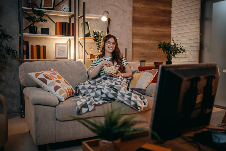 a woman watching tv inside her home