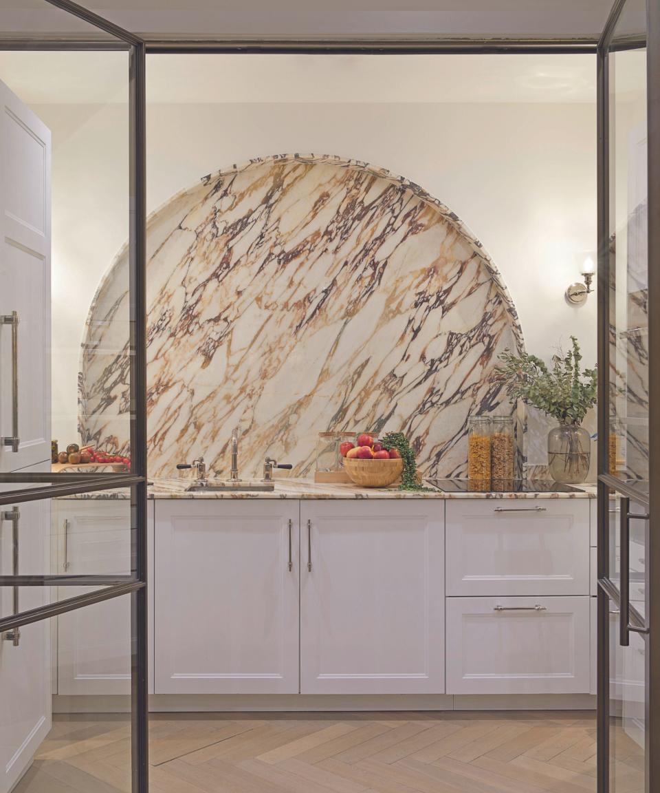 Kitchen with half moon backsplash in marble