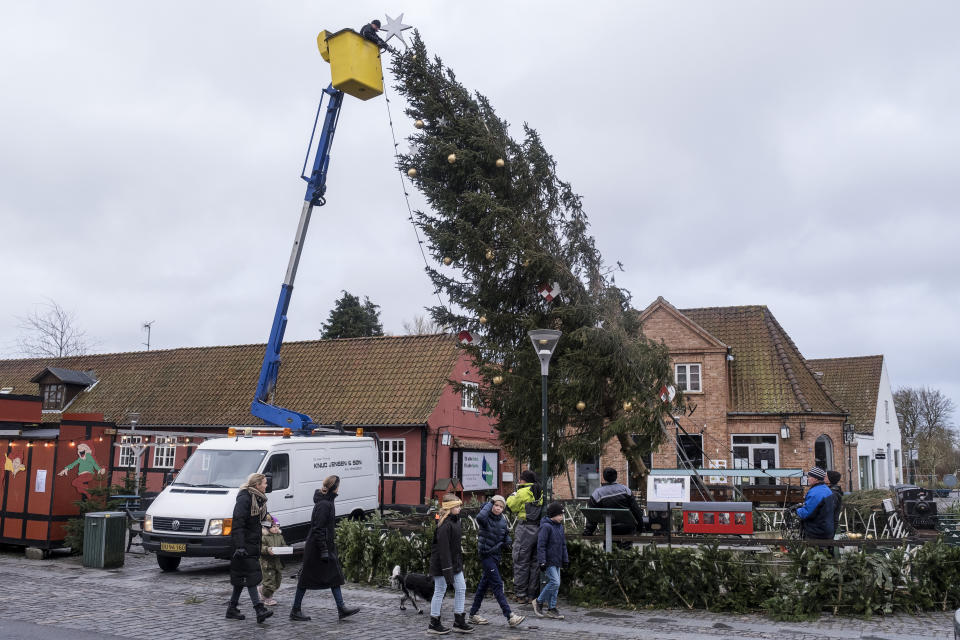 The Christmas tree is cut down after it was damaged in the storm in Aakirkeby, on the isle of Bornholm, Denmark, Friday Dec. 22, 2023. (Pelle Rink/Ritzau Scanpix via AP)