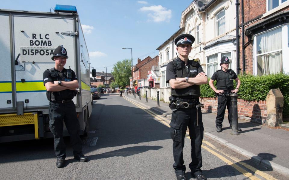 A military bomb disposal team arrive at the house in Withington which was earlier raided by police - Credit:  David Rose