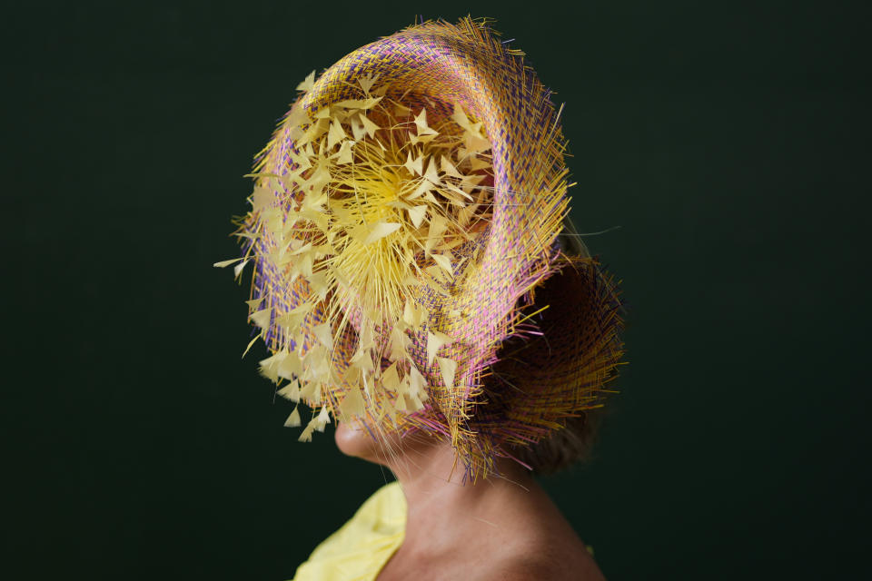 A race fan walks through the grounds of Churchill Downs before the 150th running of the Kentucky Derby horse race Saturday, May 4, 2024, in Louisville, Ky. (AP Photo/Charlie Riedel)