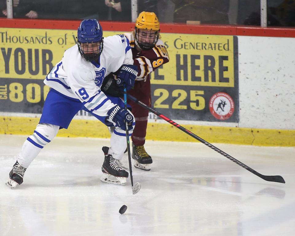 Braintree's Matt Harvey battles Weymouth's Jack Brady for the puck during second period action of their game in the Round of 32 game in the Division 1 state tournament at Zapustas Ice Arena in Randolph on Wednesday, March 1, 2023.