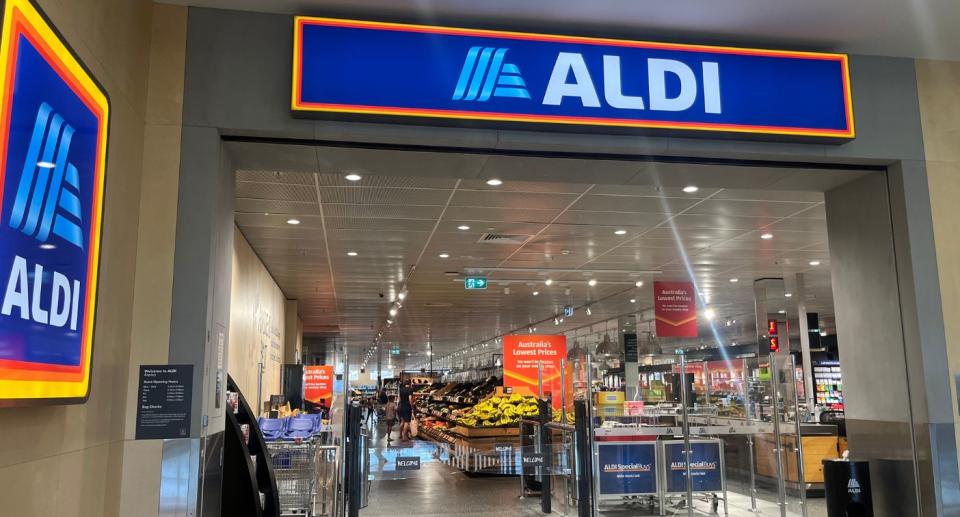 Aldi shop front with fruit section visible inside.