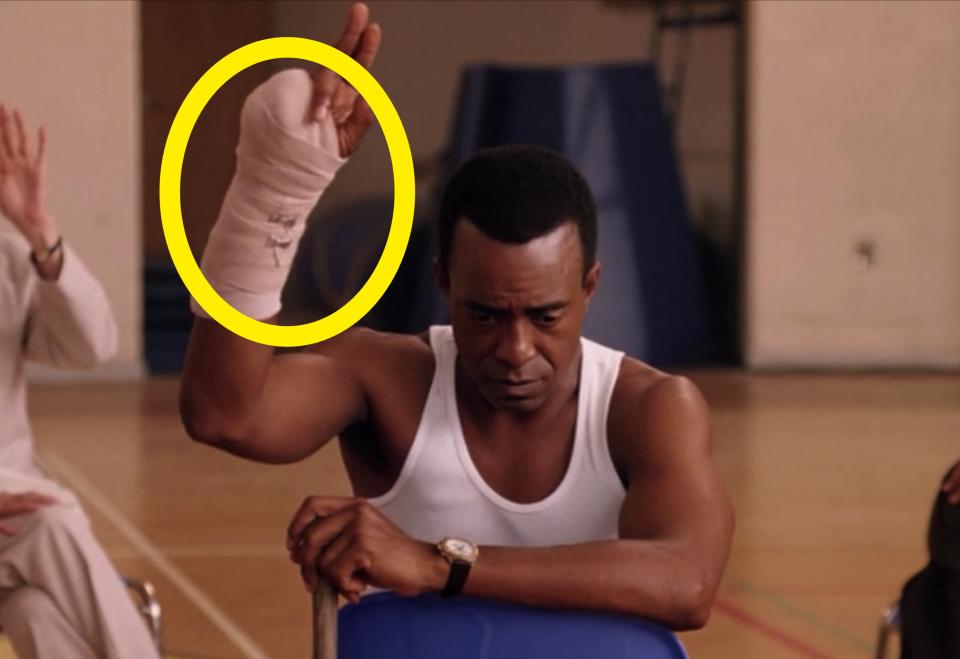 Tim Meadows holding up his arm with the cast on it