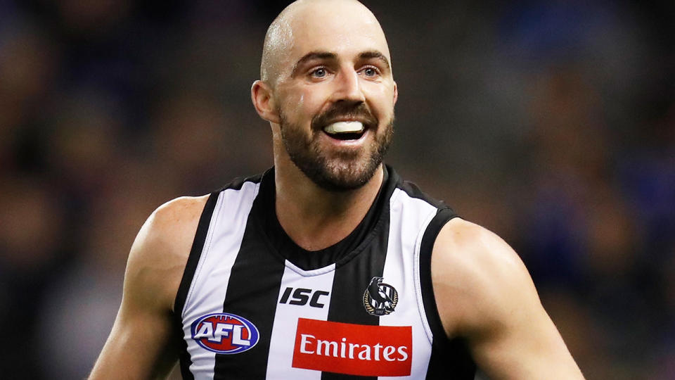 Collingwood's Steele Sidebottom is pictured celebrating a goal.