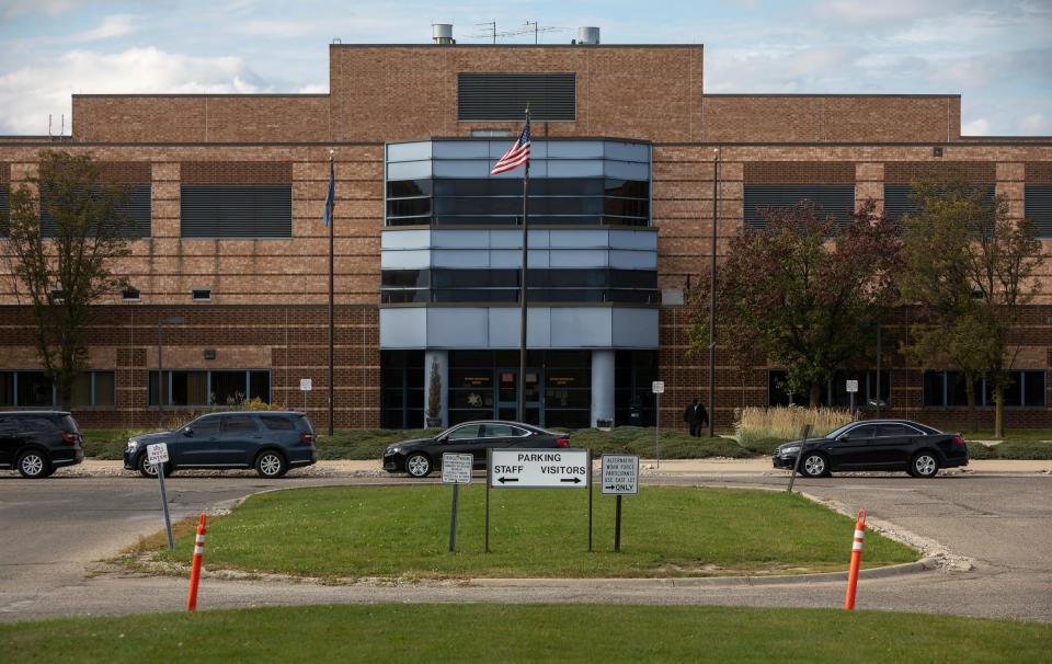 Four cars are parked in front of the Detroit William Dickerson Detention Facility entrance on Thursday, Oct. 12, 2023.