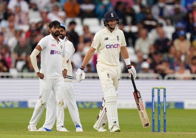 England’s Joe Root smiles after India refer an LBW decision