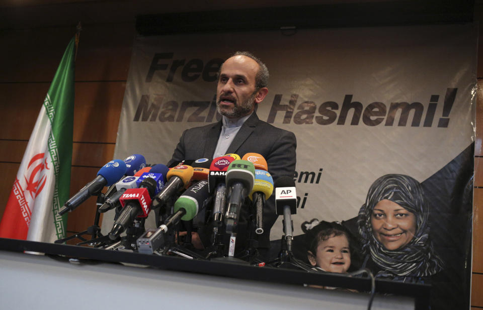 Paiman Jebeli, deputy chief of Iran's state IRIB broadcaster gives a press briefing about American-born news anchor who works on Iranian state television's English-language service, Marzieh Hashemi, shown in banner, in Tehran, Iran, Wednesday, Jan. 16, 2019. Hashemi has been arrested after flying into the U.S., the broadcaster reported Wednesday. The reported detention of Press TV's Hashemi, born Melanie Franklin of New Orleans, comes as Iran faces increasing criticism of its own arrests of dual nationals and others with Western ties, previously used as bargaining chips in negotiations with world powers. (AP Photo/Vahid Salemi)